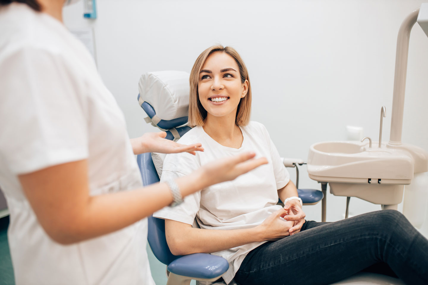Woman smiling sitting in a dentist chair